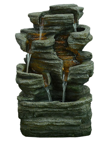 Multi-level rock cascading rock fountain is lighted up and has two waterflows